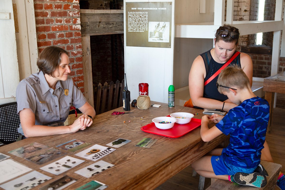 A park ranger works on an activity inside Fort Pulaski