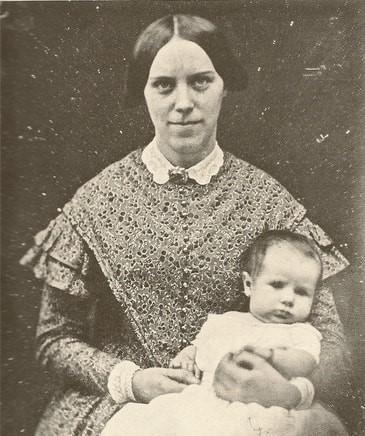 Black and White image of Mary Lawrence, a woman in the late 1800s sitting in a chair holding a baby