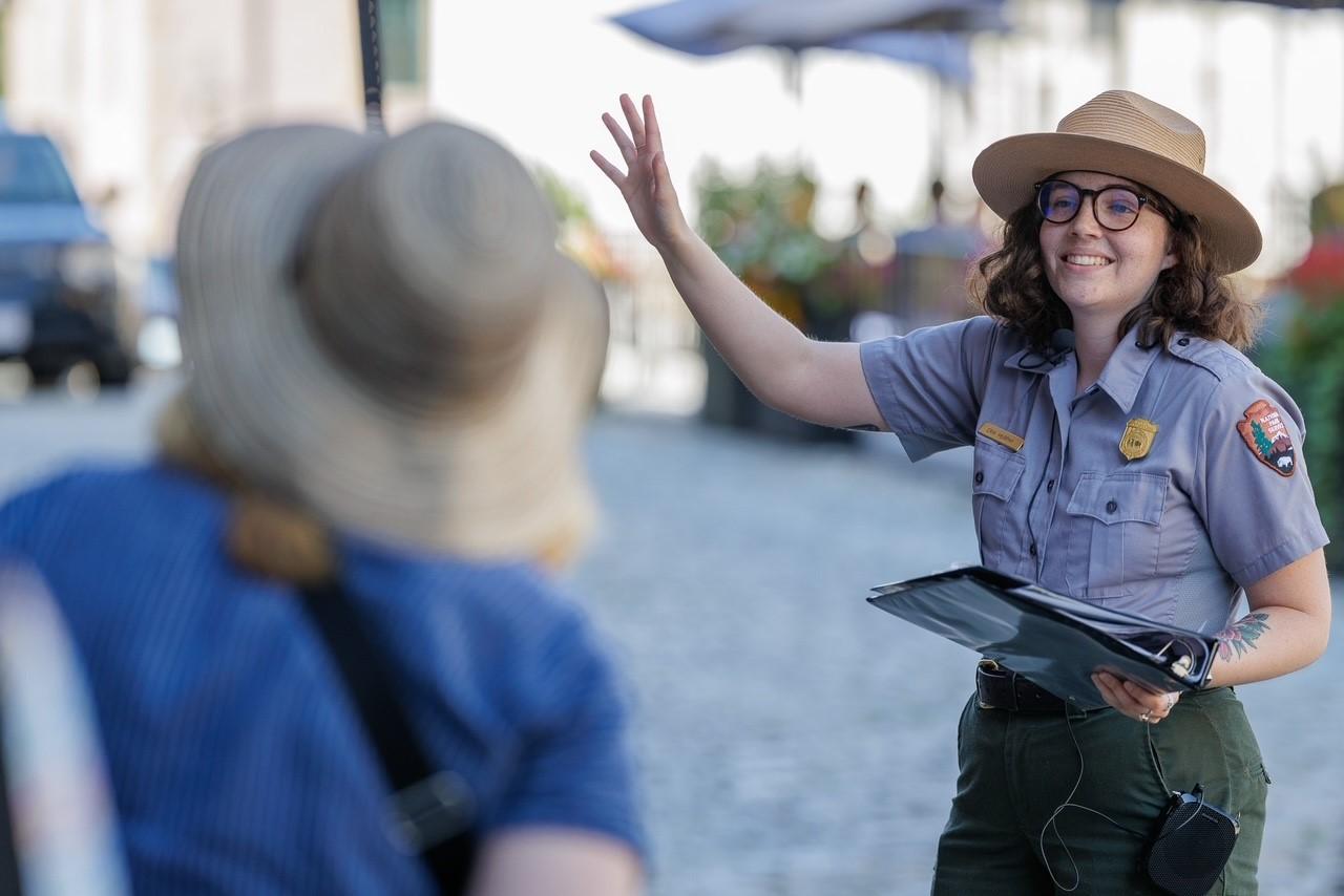 Park ranger in uniform giving a walking tour on the cobble-stoned streets of New Bedford.  The range