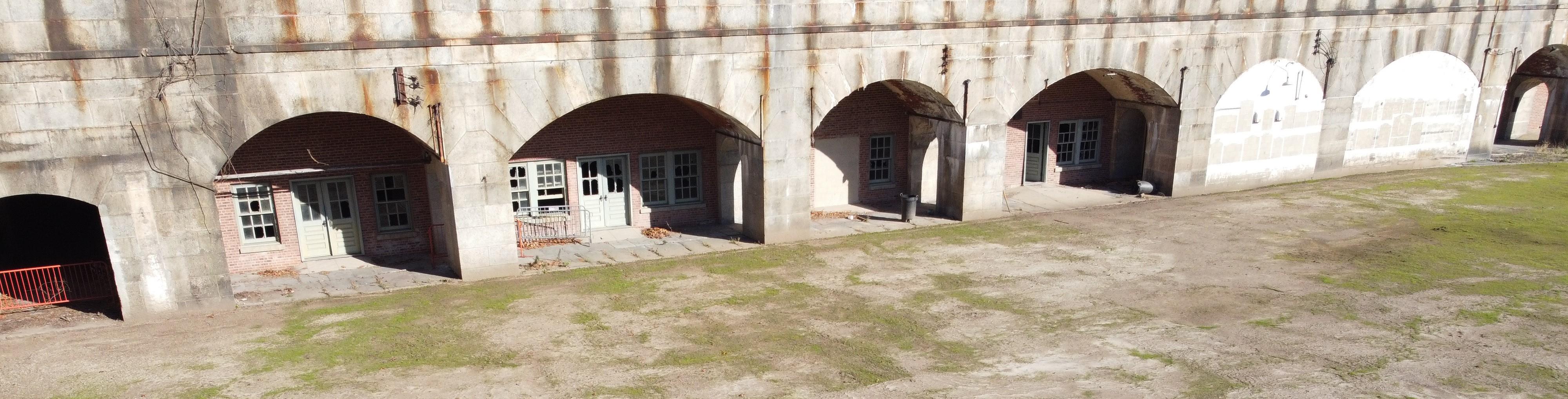 Interior of fort with curved doors and parade ground.