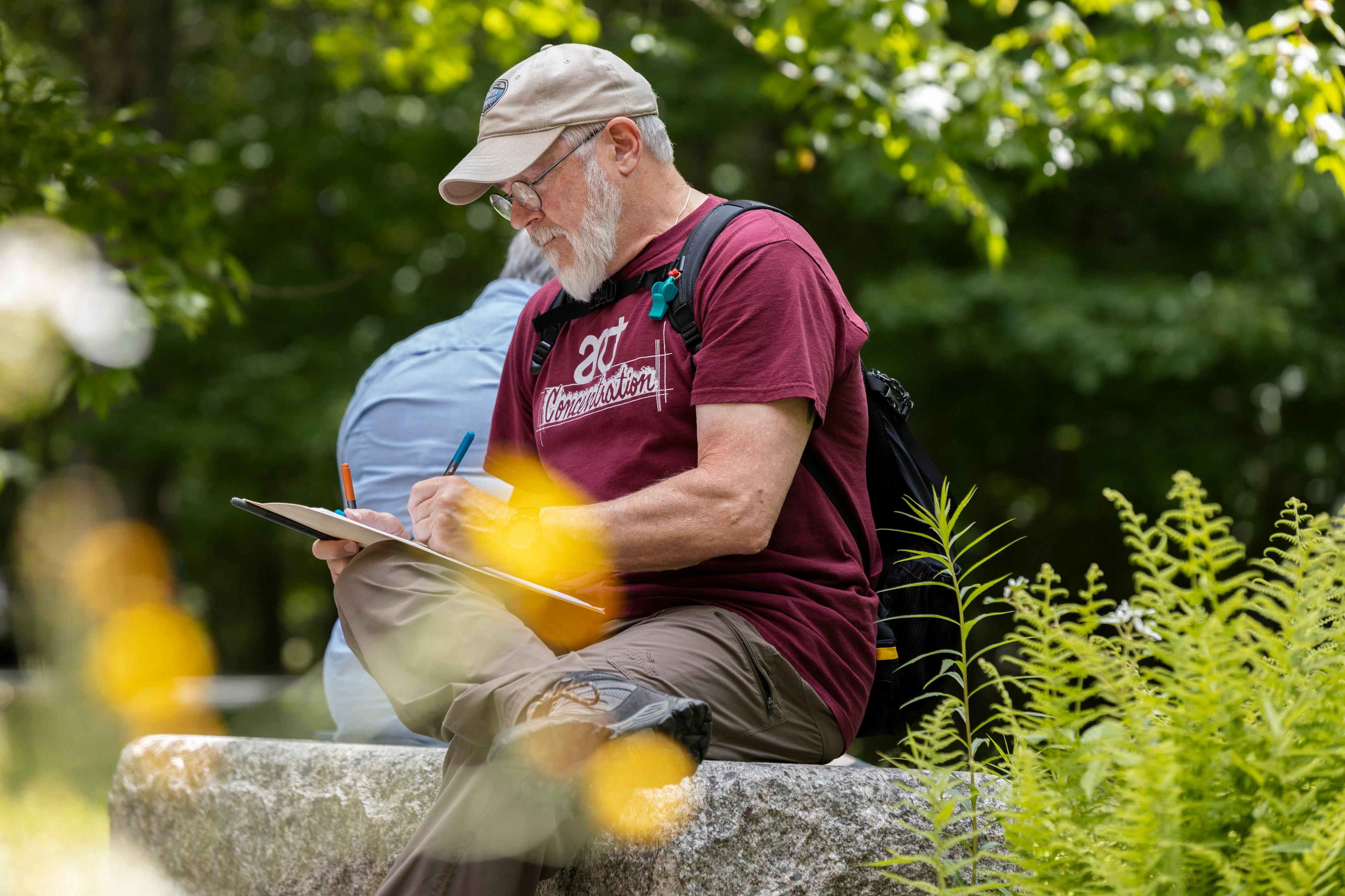 An artist works on a piece in the park.