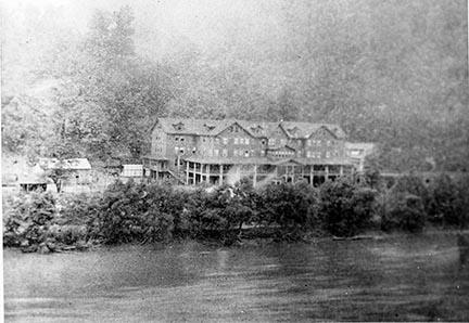 Historic image of a large hotel next to a river