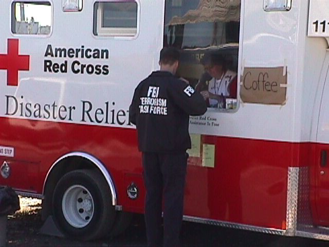 An FBI agent getting coffee from an American Red Cross truck