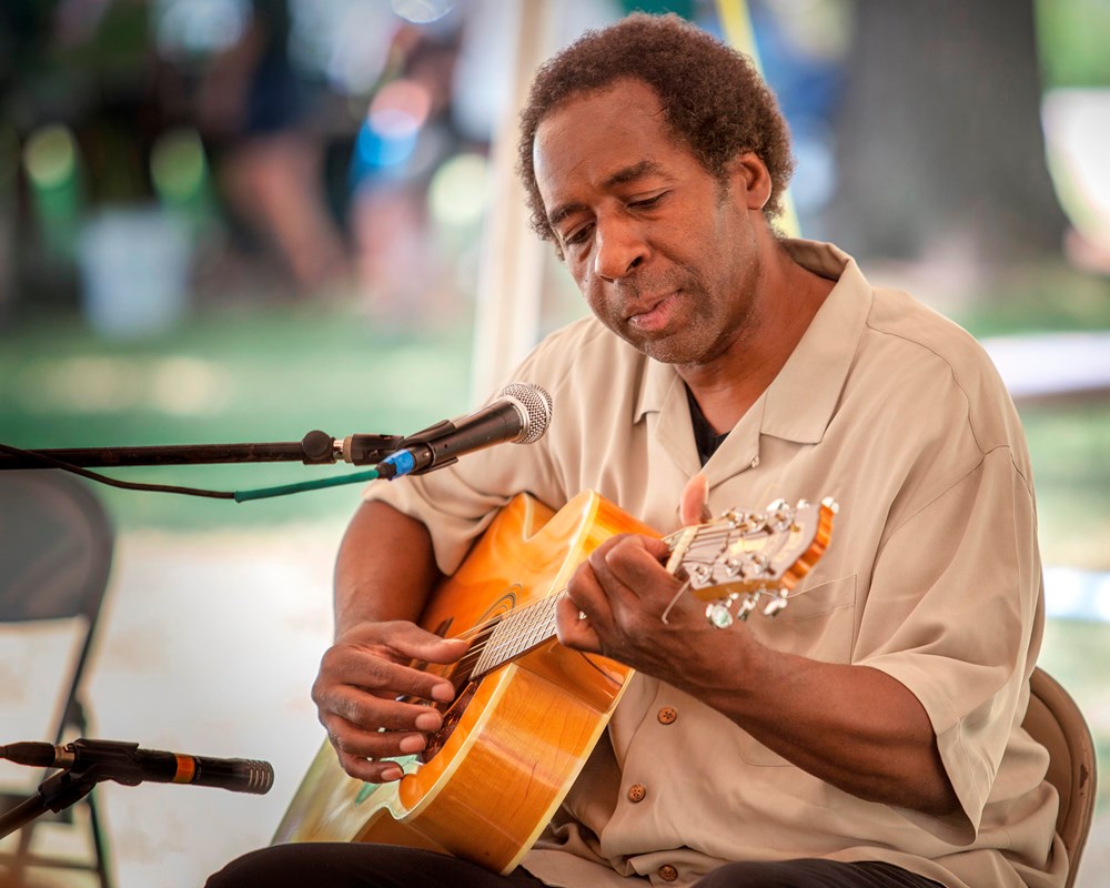 A man playing a guitar.