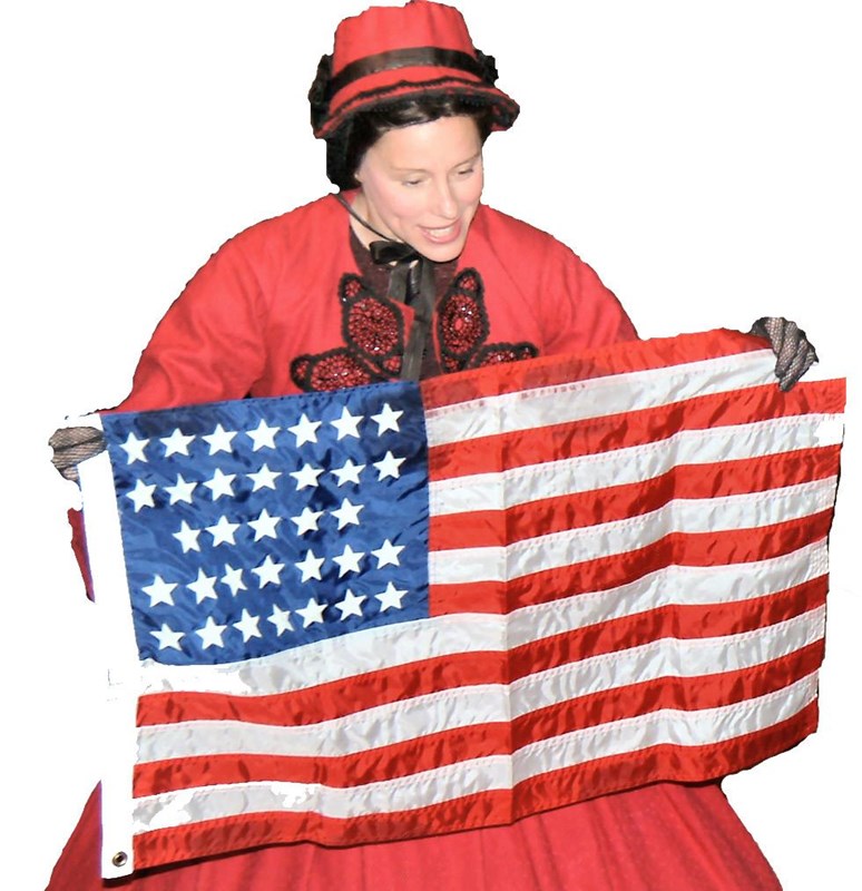 Woman in 19th century red dress holding an American flag