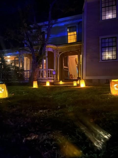 The wayside front door with luminary bags leading to it.