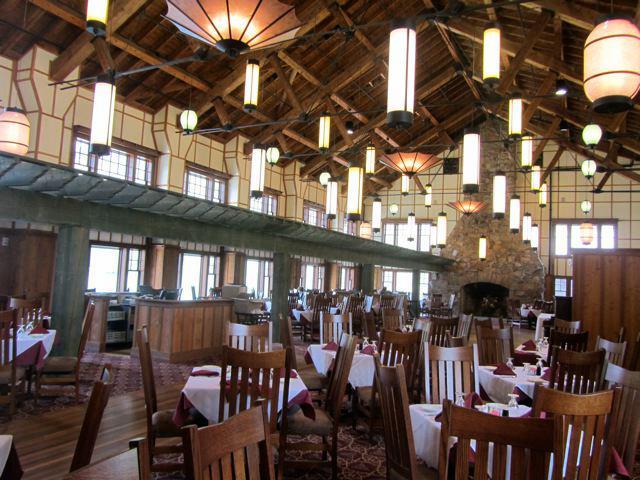 high-ceilinged room with large windows and Japanese lantern-shaped light fixtures filled with tables