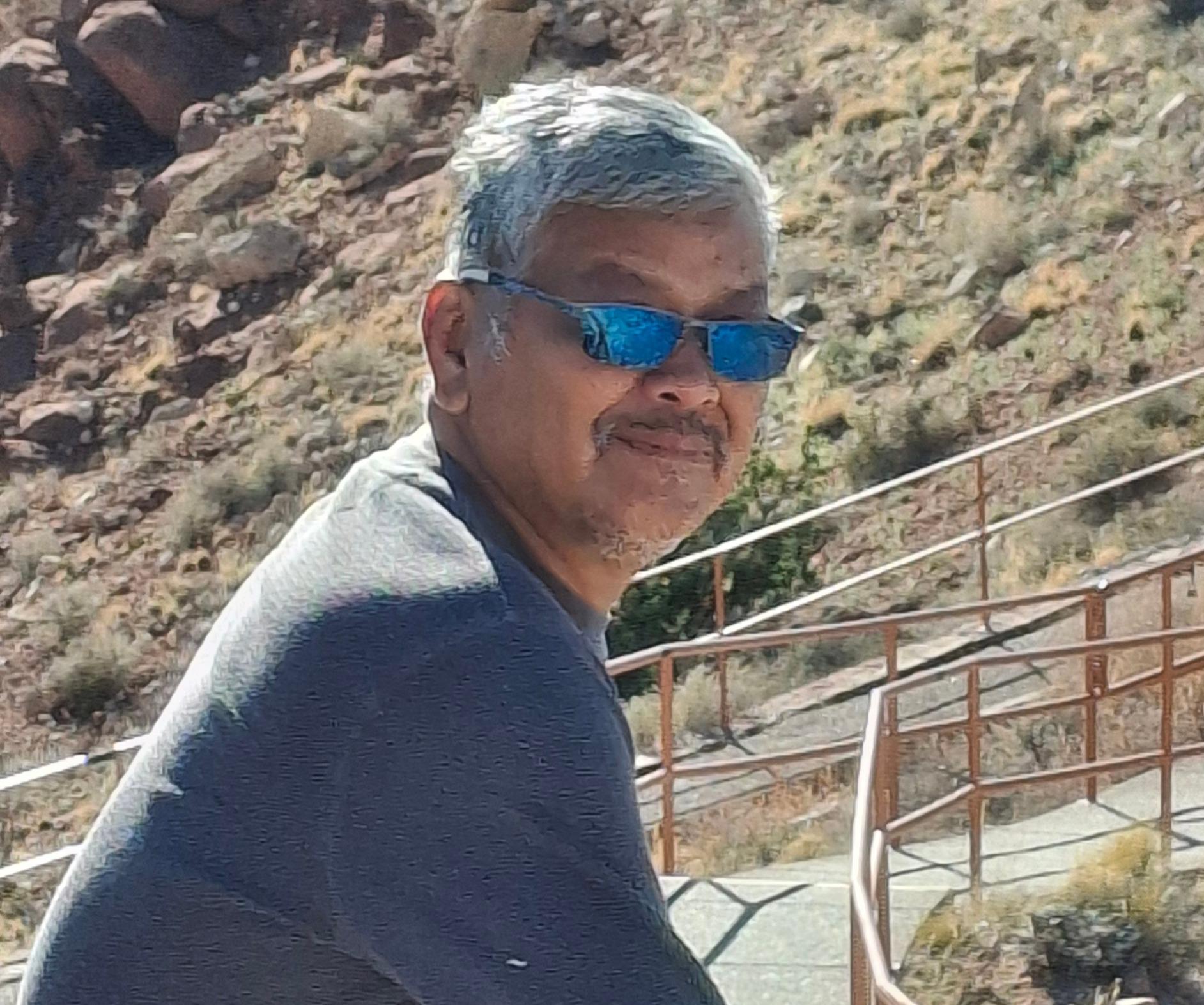A man in sunglasses outside smiling