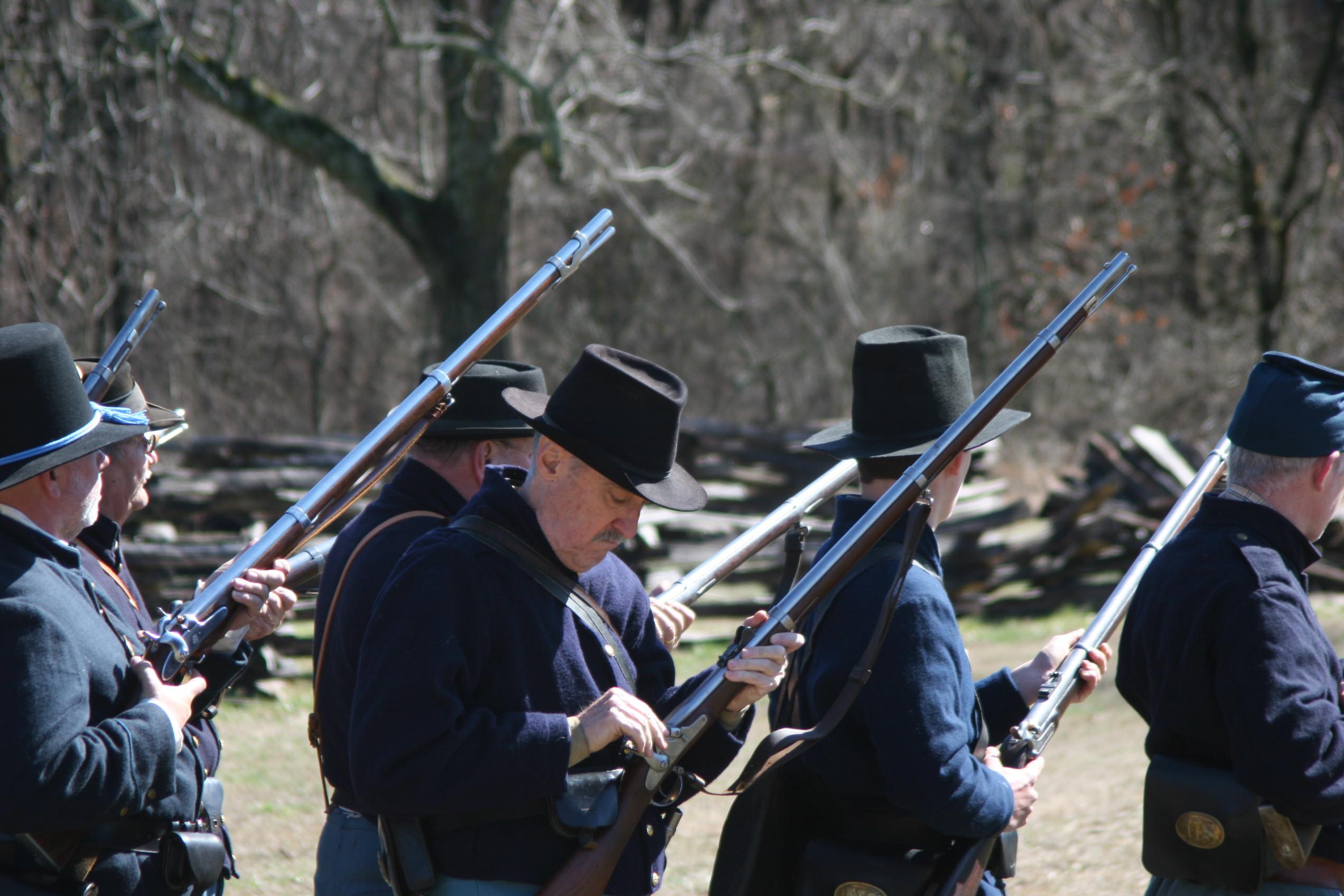 Image of union solders in the recovery position and background of trees.
