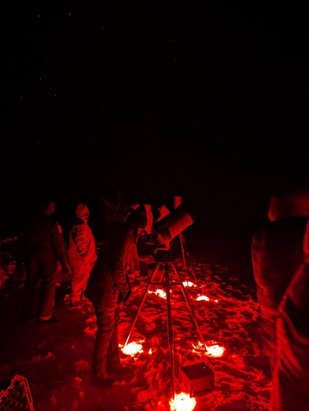 Visitors line up for telescopic views of a celestial object.