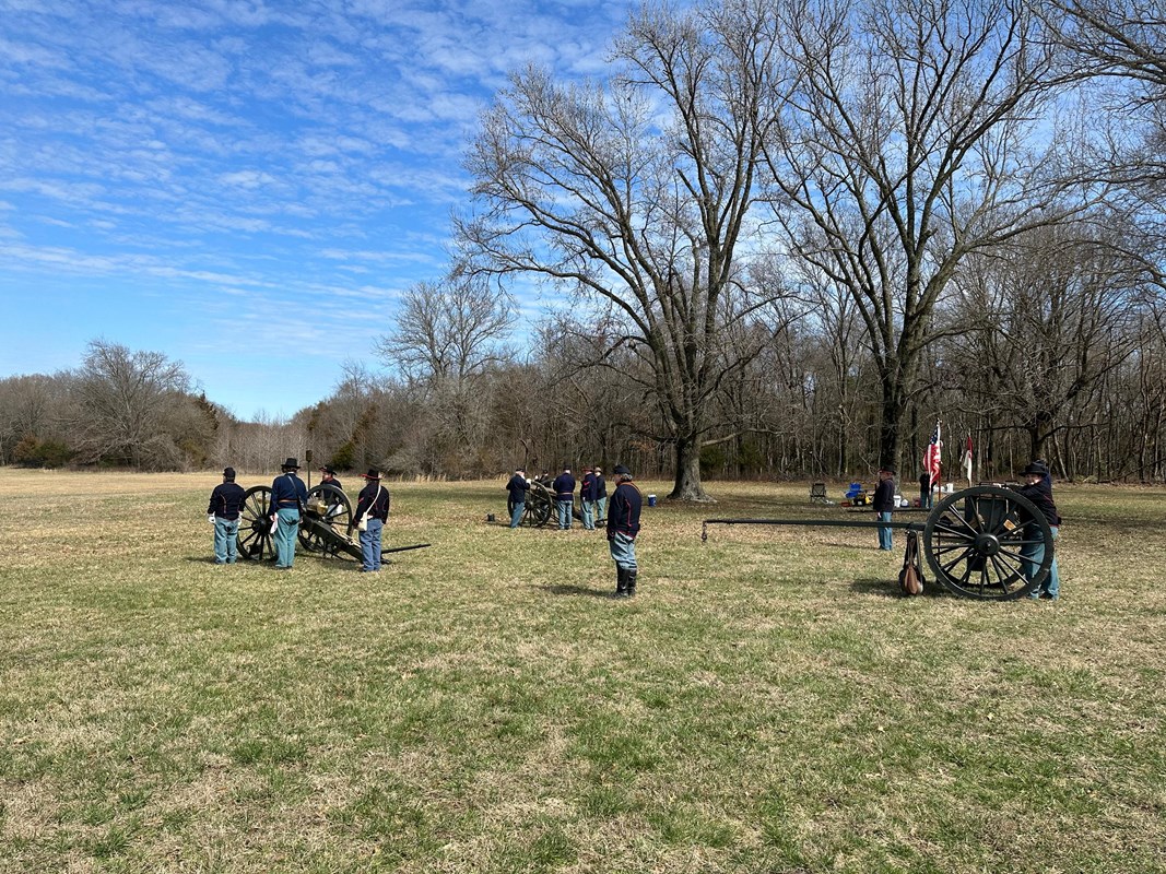 Photo six pound cannon and limber in field, trees in the background and union soldiers
