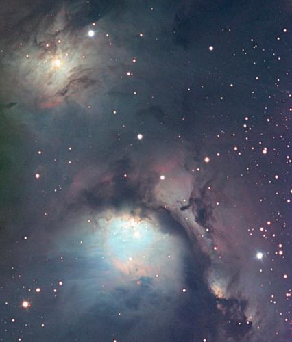 Hazy clouds of colorful gas streak across the image.