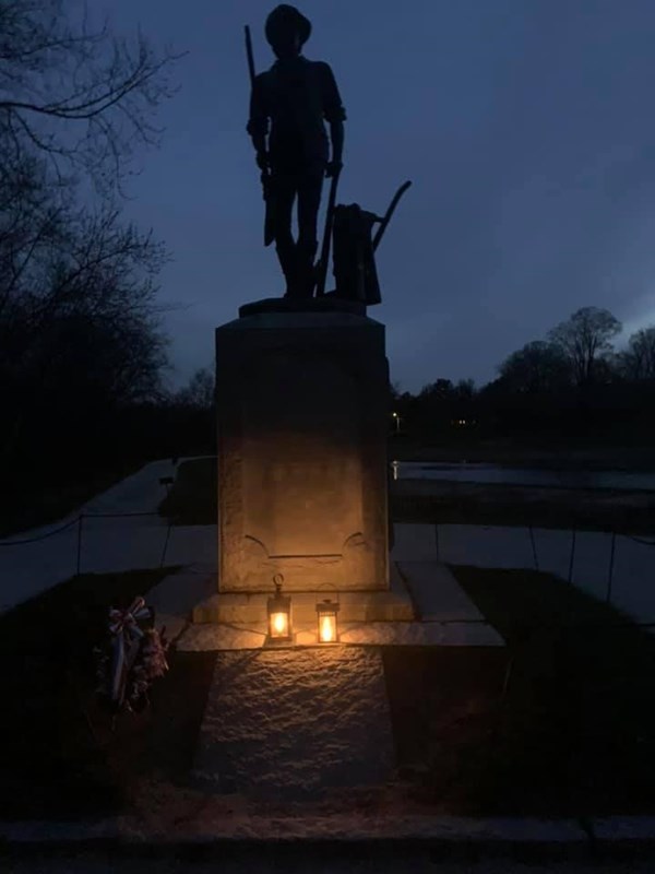 Grave of British Soldiers illuminated by two lanterns.