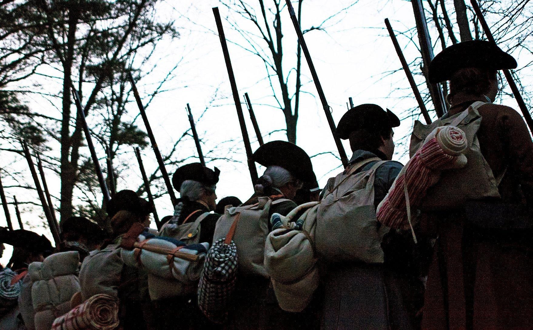 Revolutionary War Colonial soldiers viewed from behind to show equipment and packs