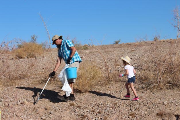 man and child clean up litter