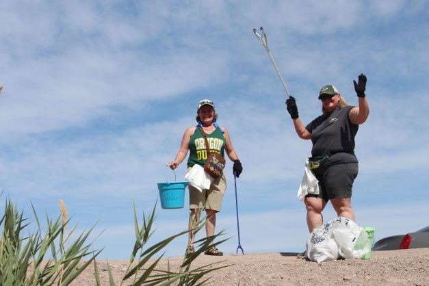 Two volunteers cleanup litter