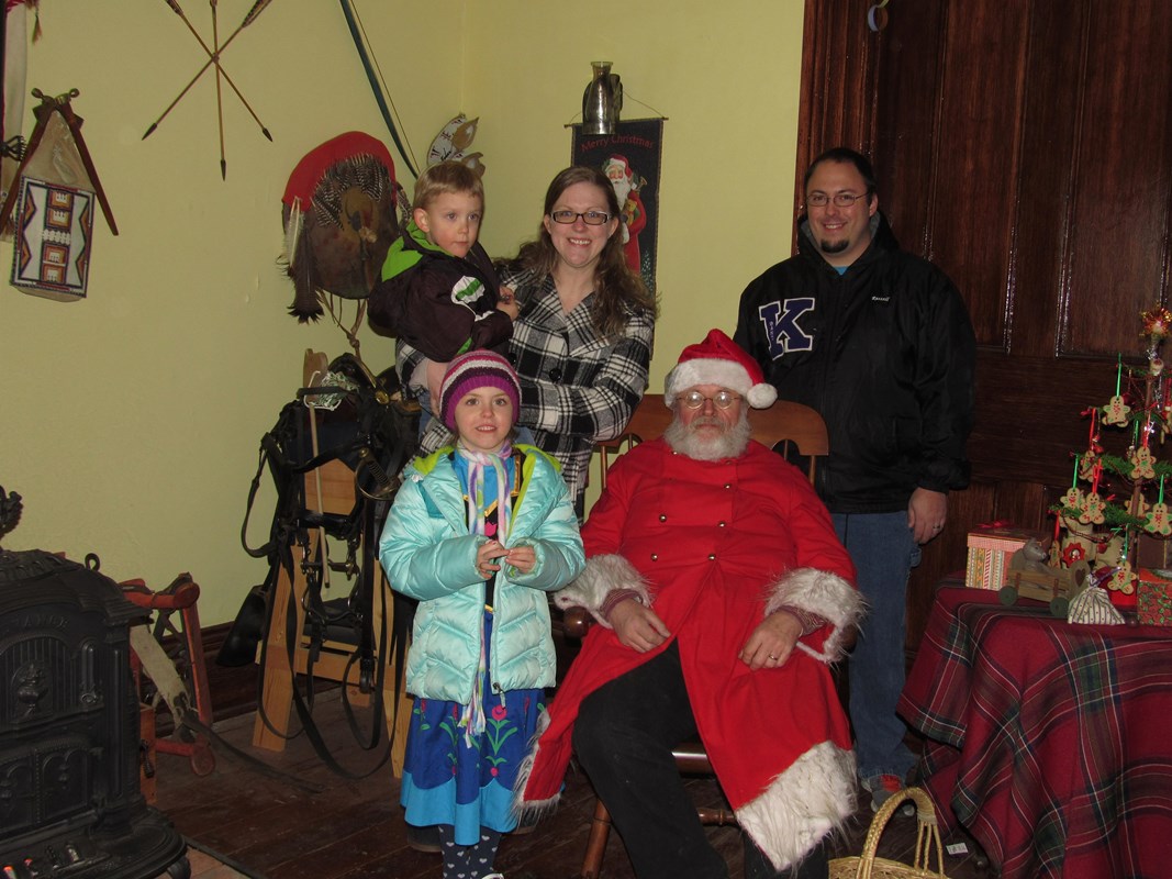 Two adults and two children with Santa.