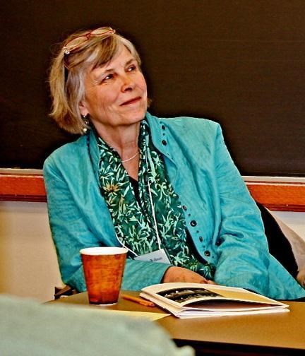 Woman in blue jacket, looking off to the right