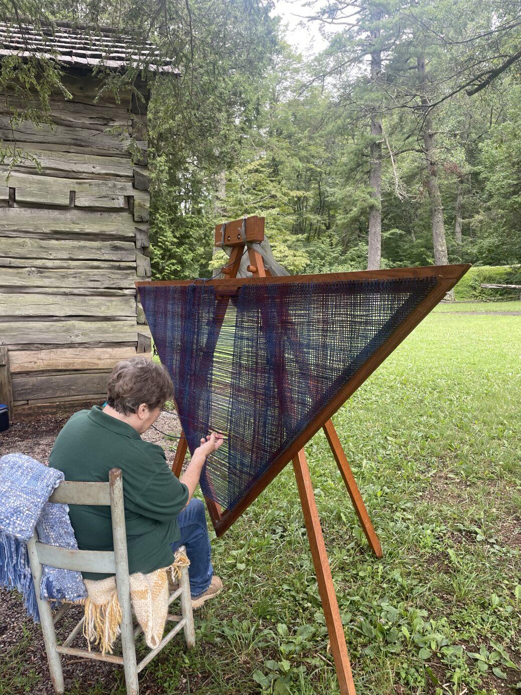 A volunteer weaving a shawl
