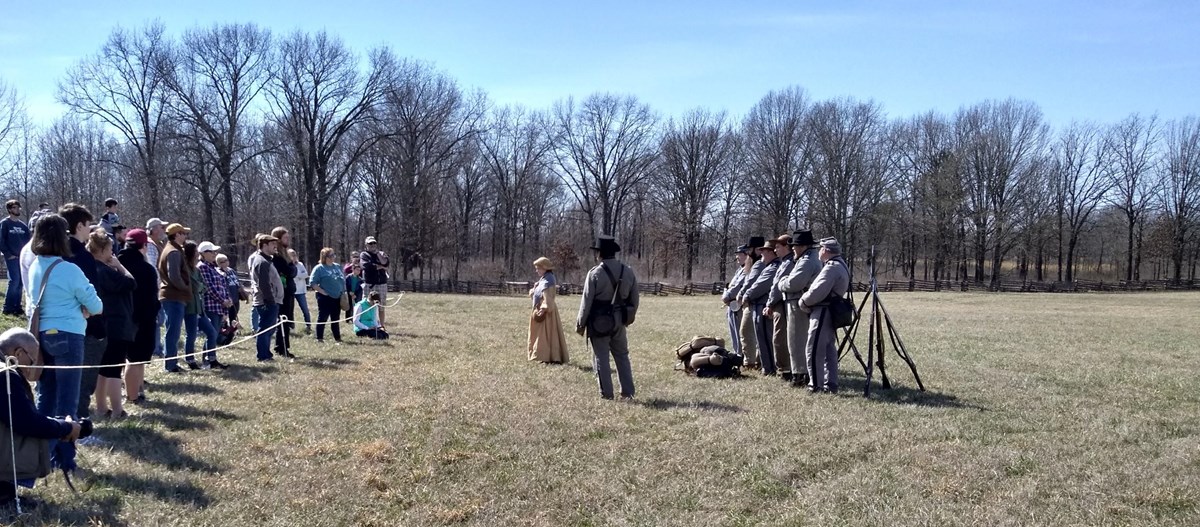 Photo of living history soldiers talking to visitors.