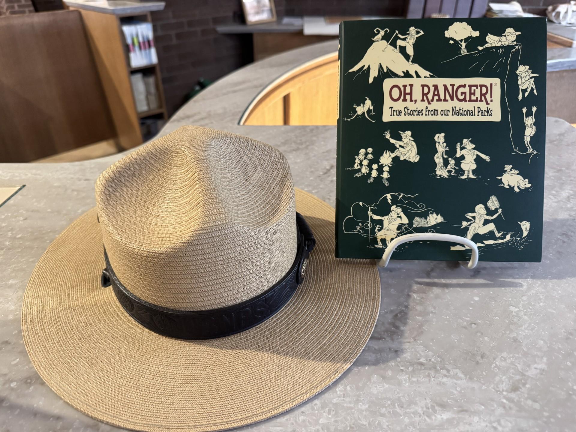 The book "Oh Ranger! True Stories from our National Parks" posed with a ranger hat.