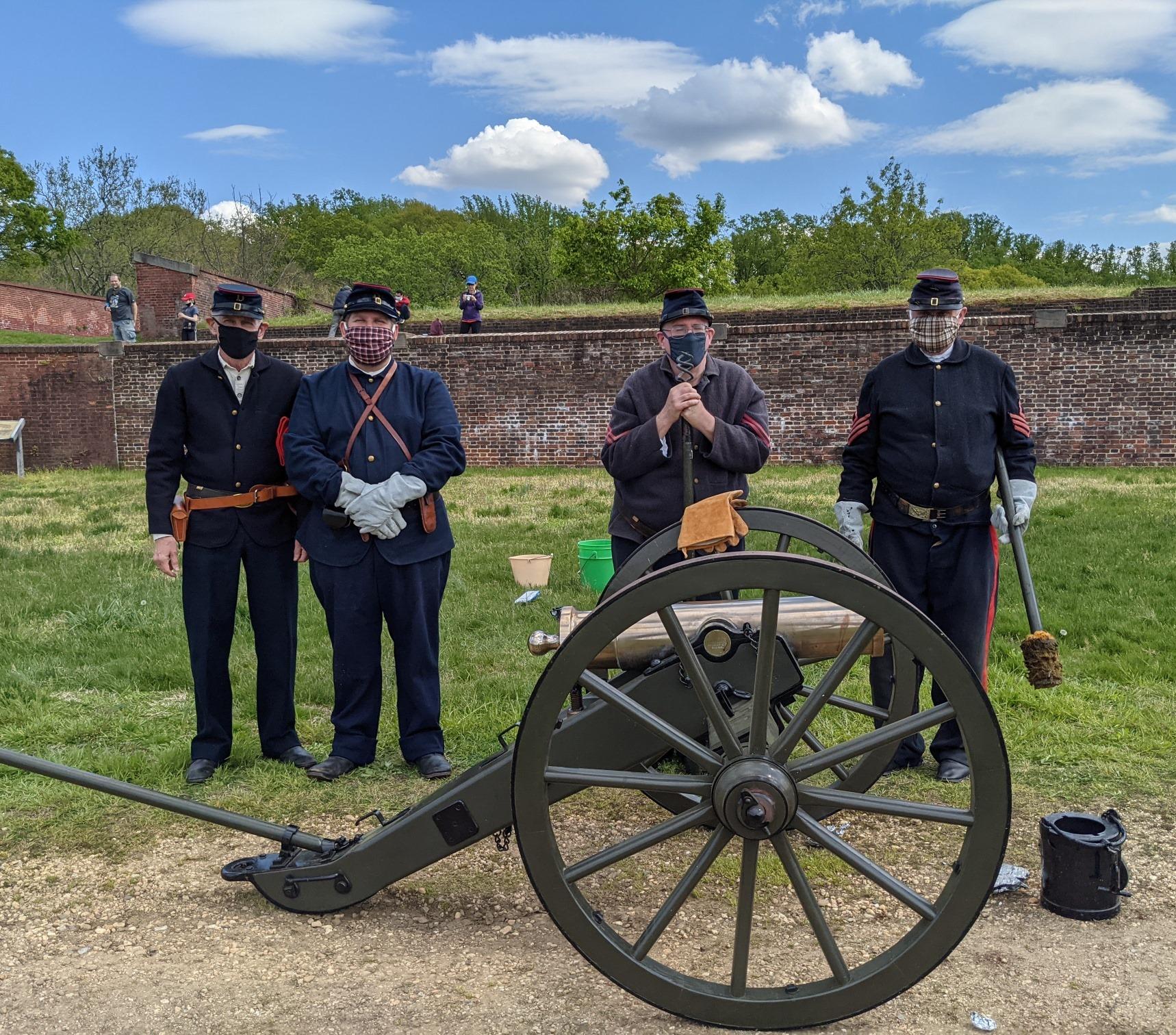 Four men in Union uniforms stand behind a cannon