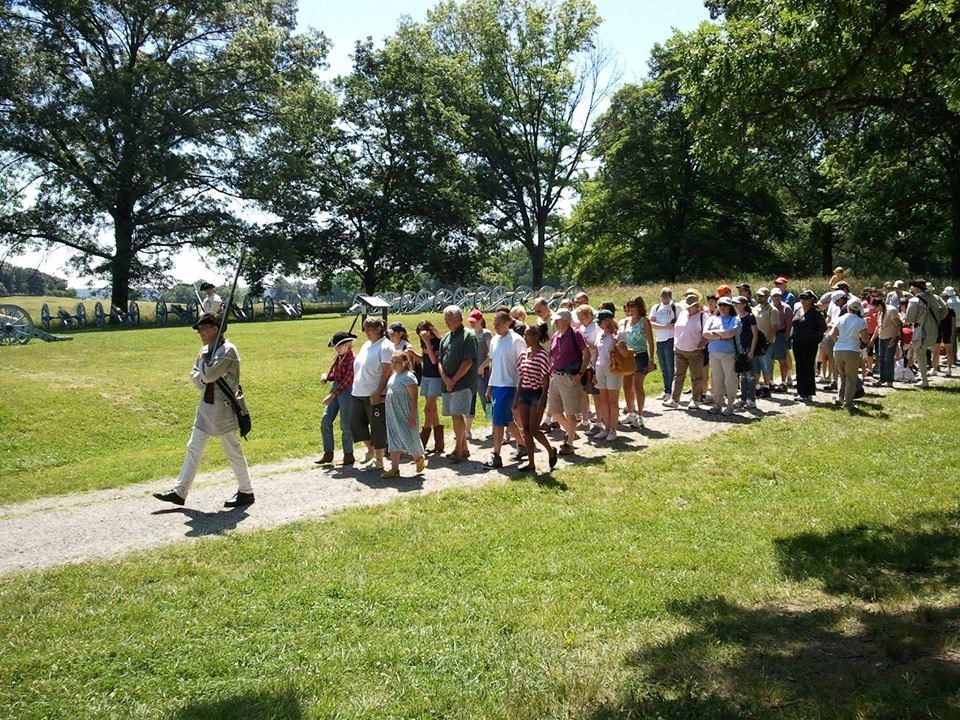 A soldier guides visitors along a trail during March-Out