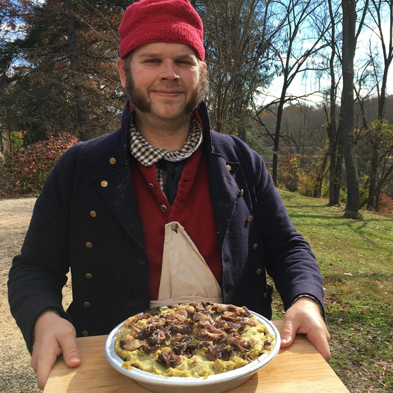 Living history volunteer War of 1812 sailor with pie