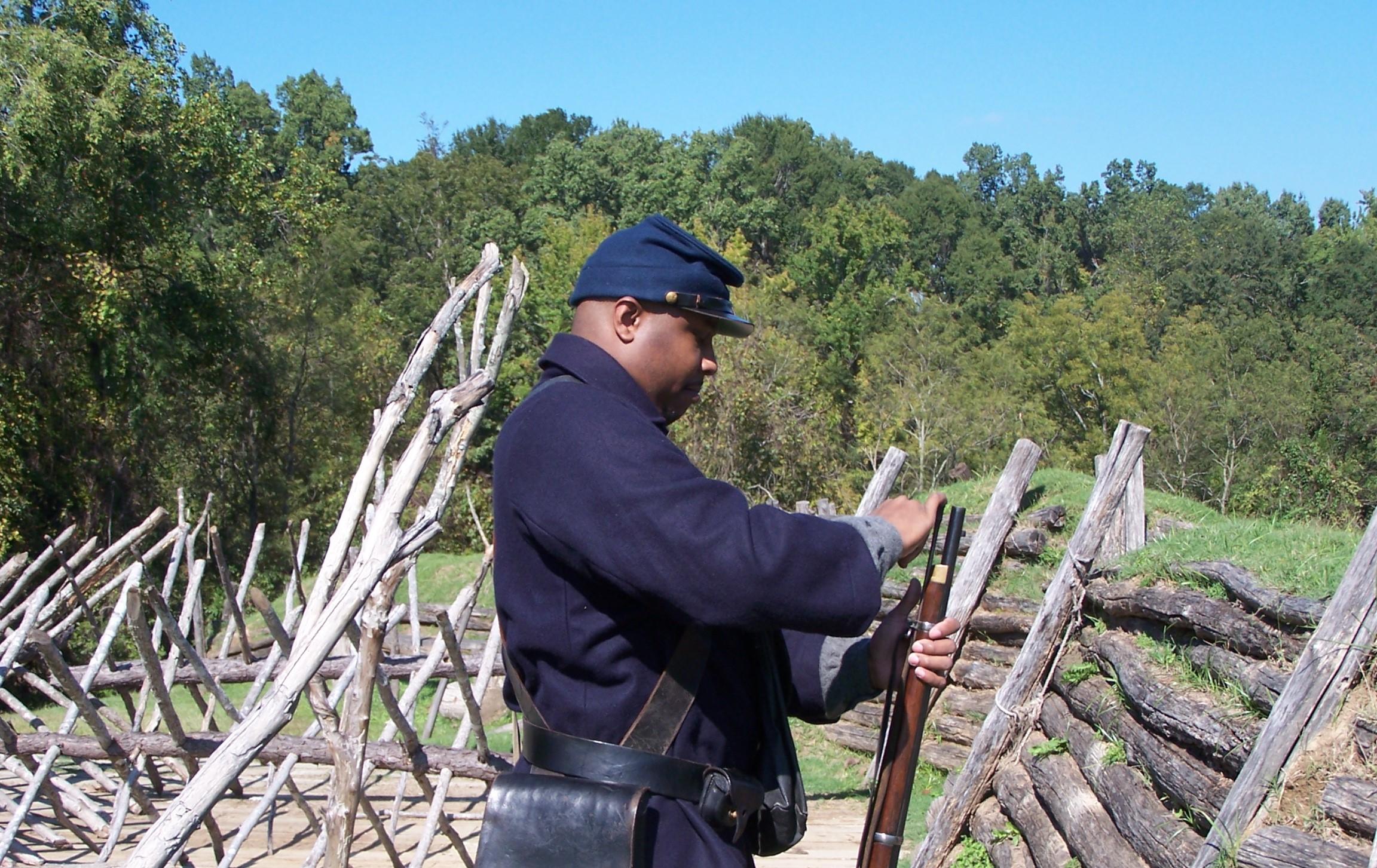 A living historian loads a rifled musket