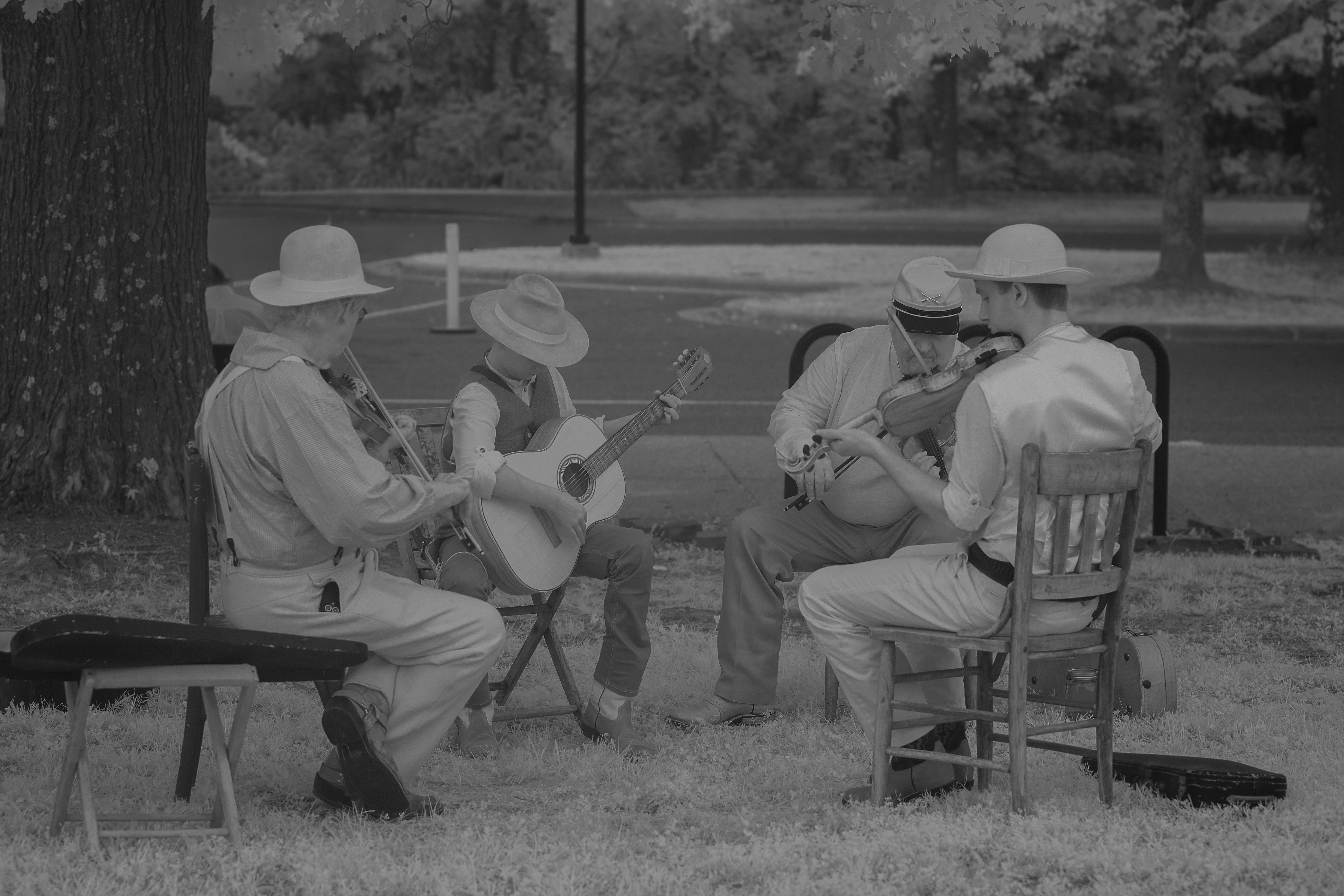 Black-and-white photo of performers playing old time music.