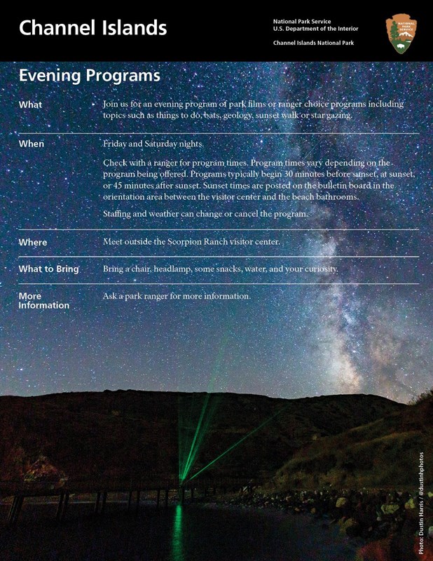 milky way stars overlooking harbor and pier.