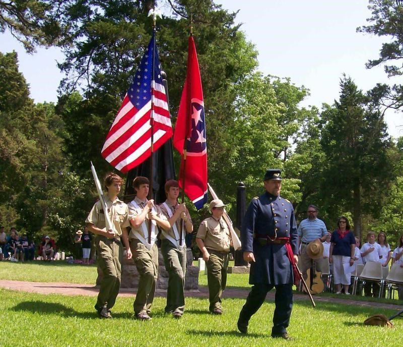 Living Historian leads a color guard made up of Boy Scouts.