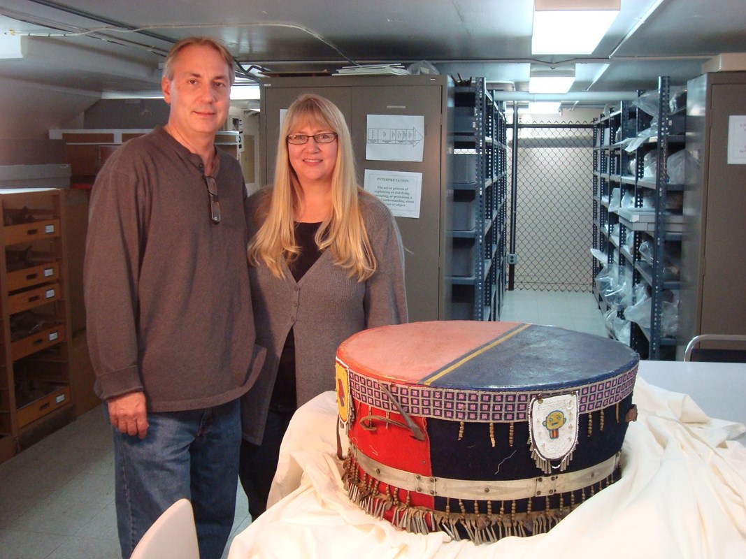 Kelly and Tammy Rundle standing next to a ceremonial drum on a table