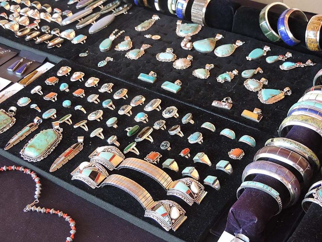 A black velvet display with tribal jewelry, mostly turquoise in silver settings.