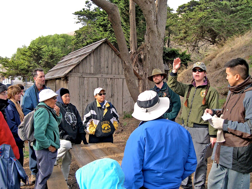 Volunteer ranger talking to visitors about island resources.