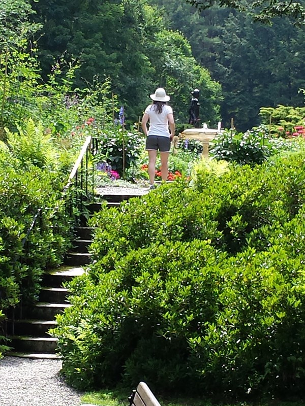 Visitor with hat in the formal gardens