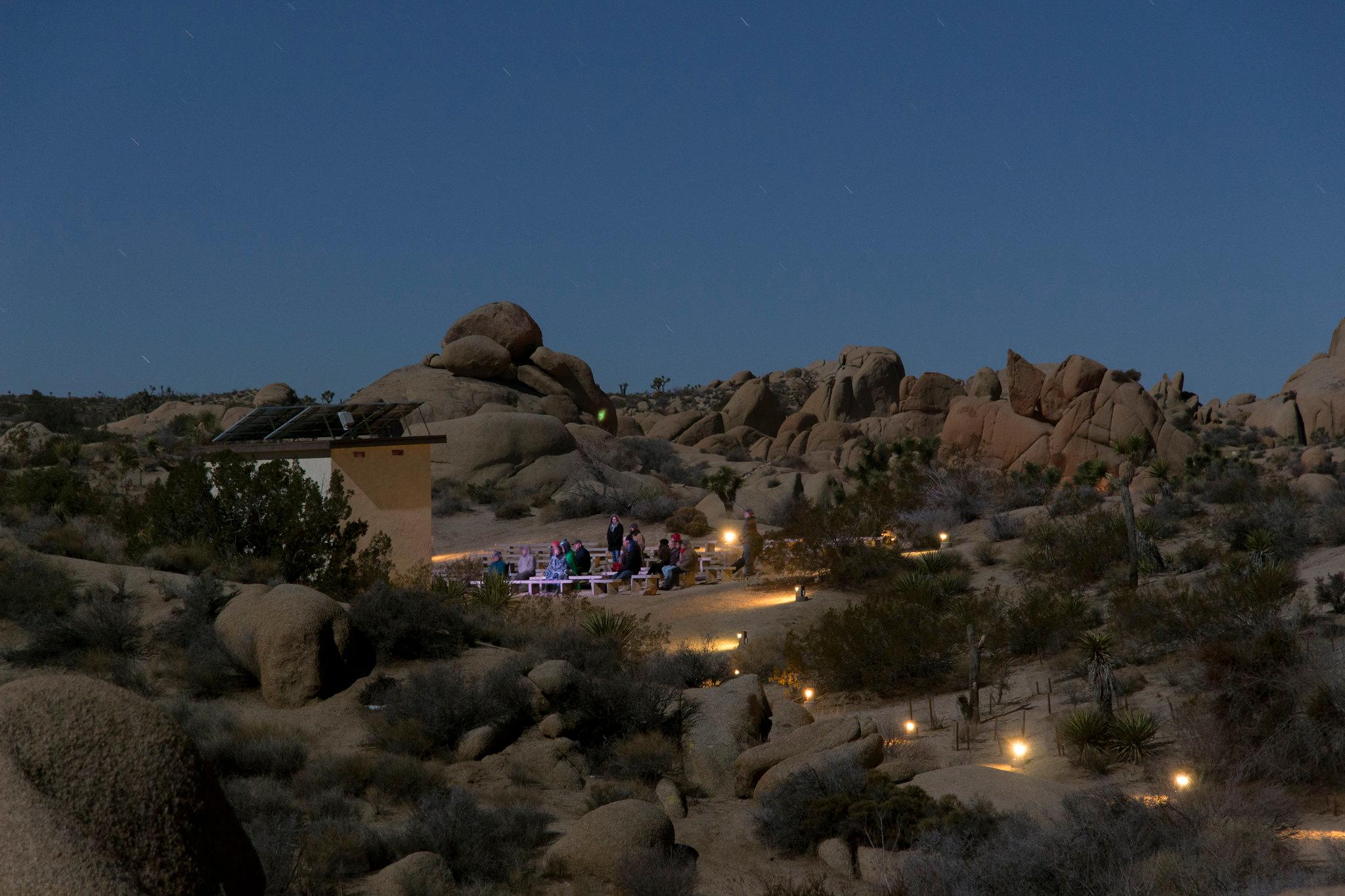 Crowd of people at night watching presentation