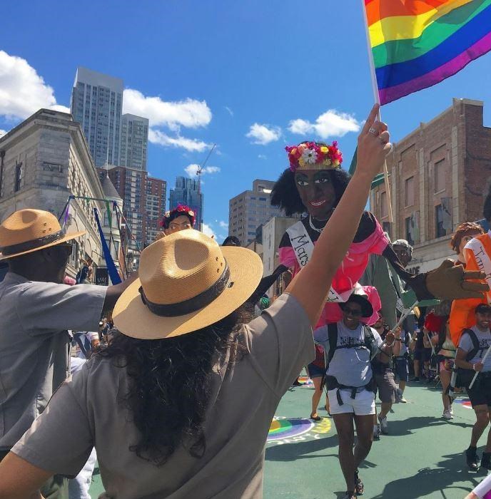 Rangers holding rainbow flags in front of a Marsha P. Johnson puppet.