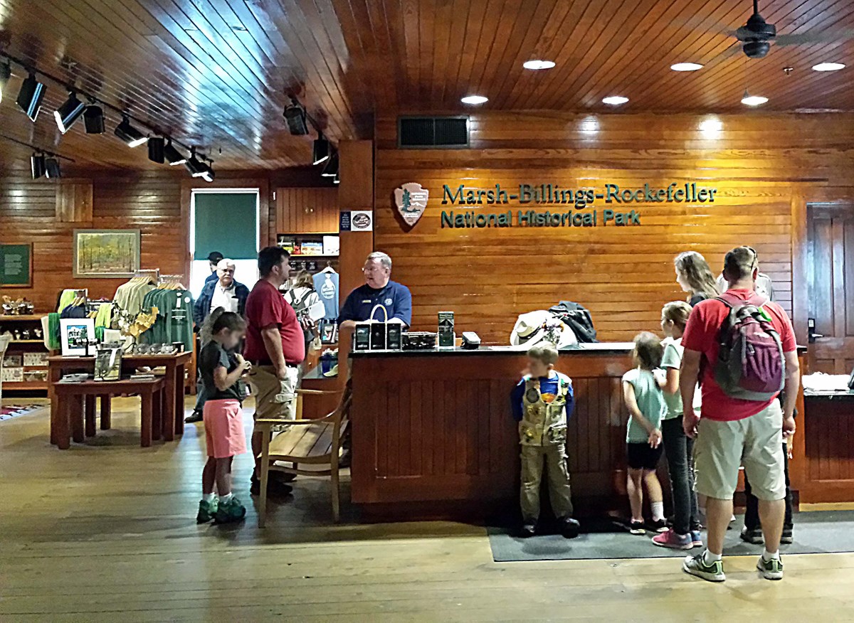 Visitors at Carriage Barn Visitor Center desk
