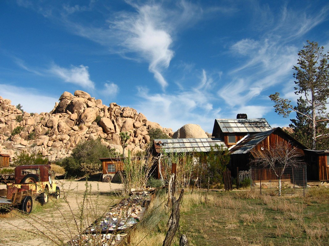 Historic wooden structure amongst desert landscape.