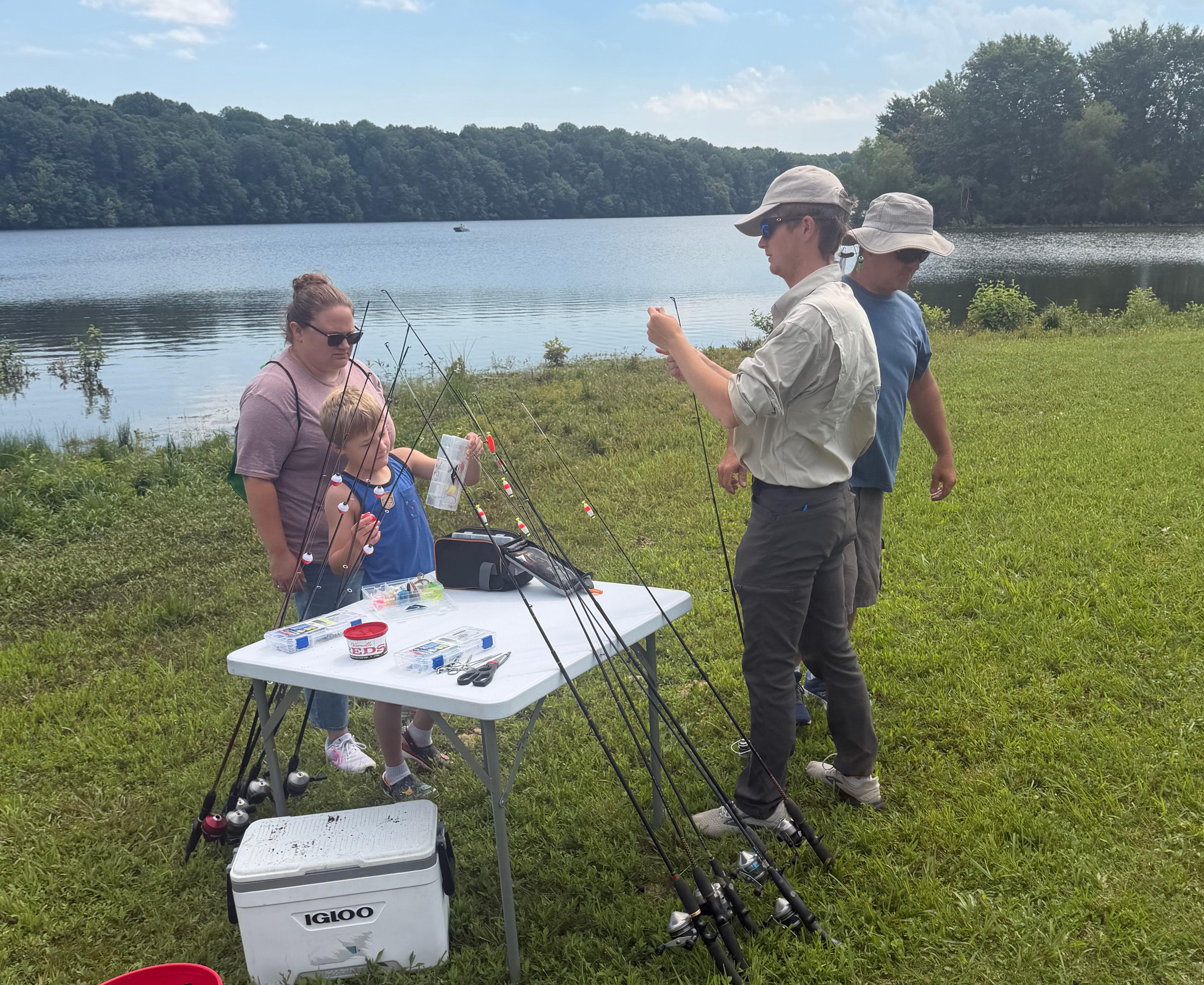 A color photo showing a fishing clinic program at a lake