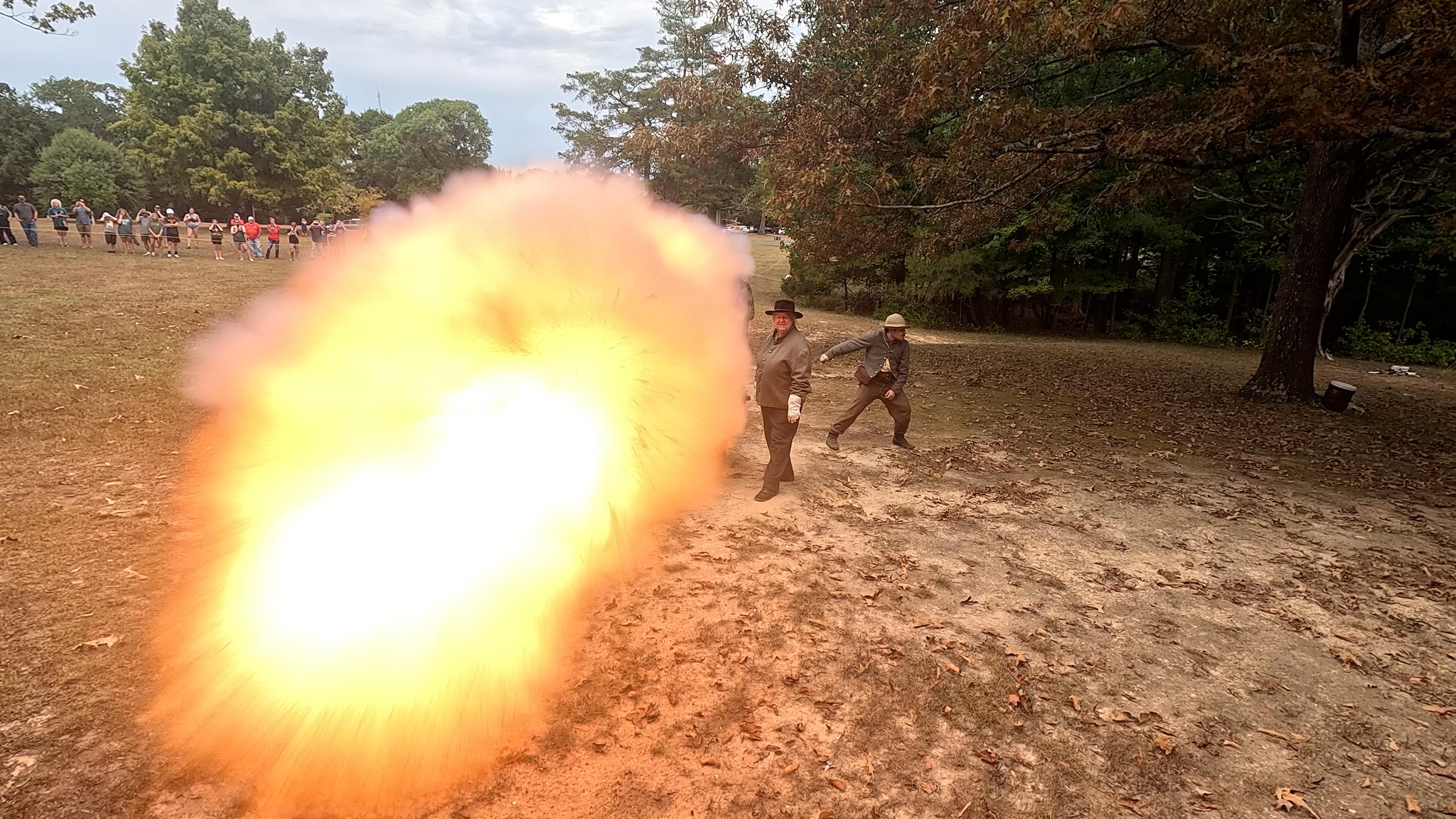 Flame belches out of a bronze cannon.