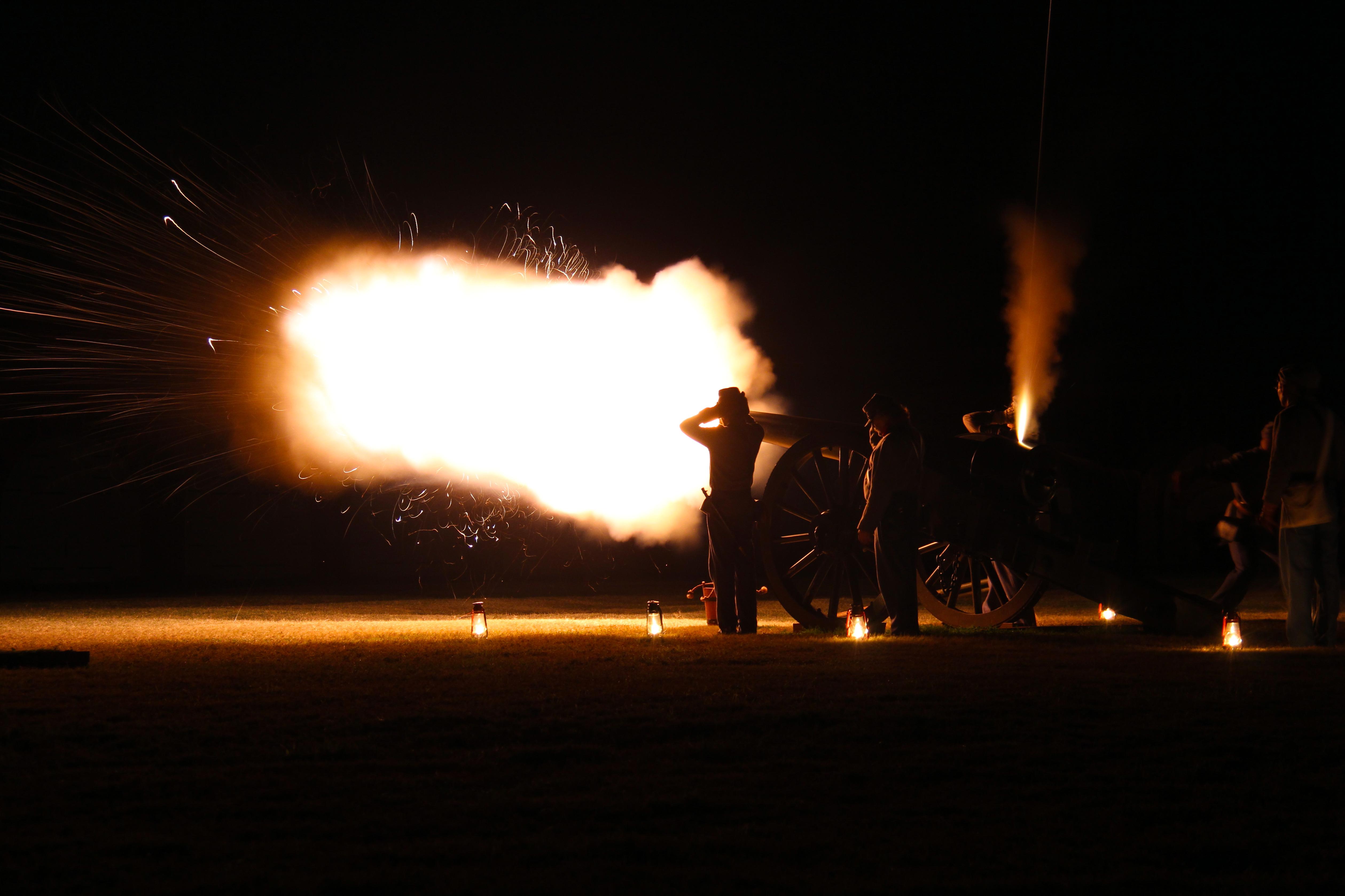 NPS artillery crew fires a cannon at night