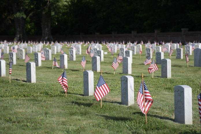 Headstones at Poplar Grove with American Flags beside.