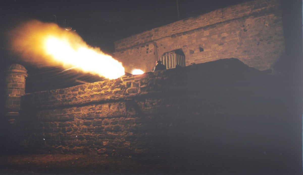 Night view of Fort Matanzas firing a Cannon - Fort has an orange glow from cannon blast