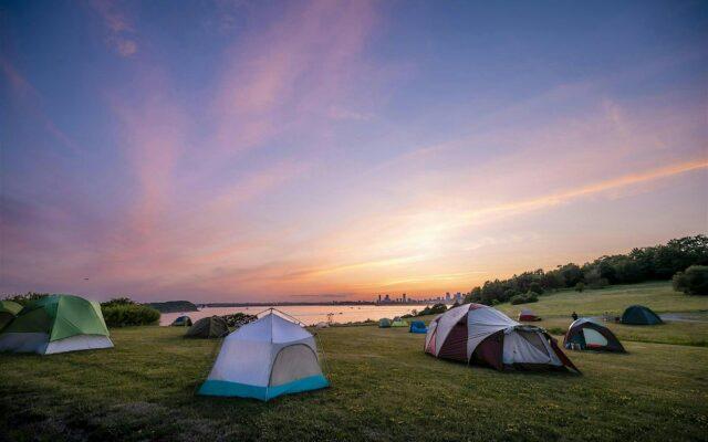 tents spotted along a hillside overlooking Boston Harbor