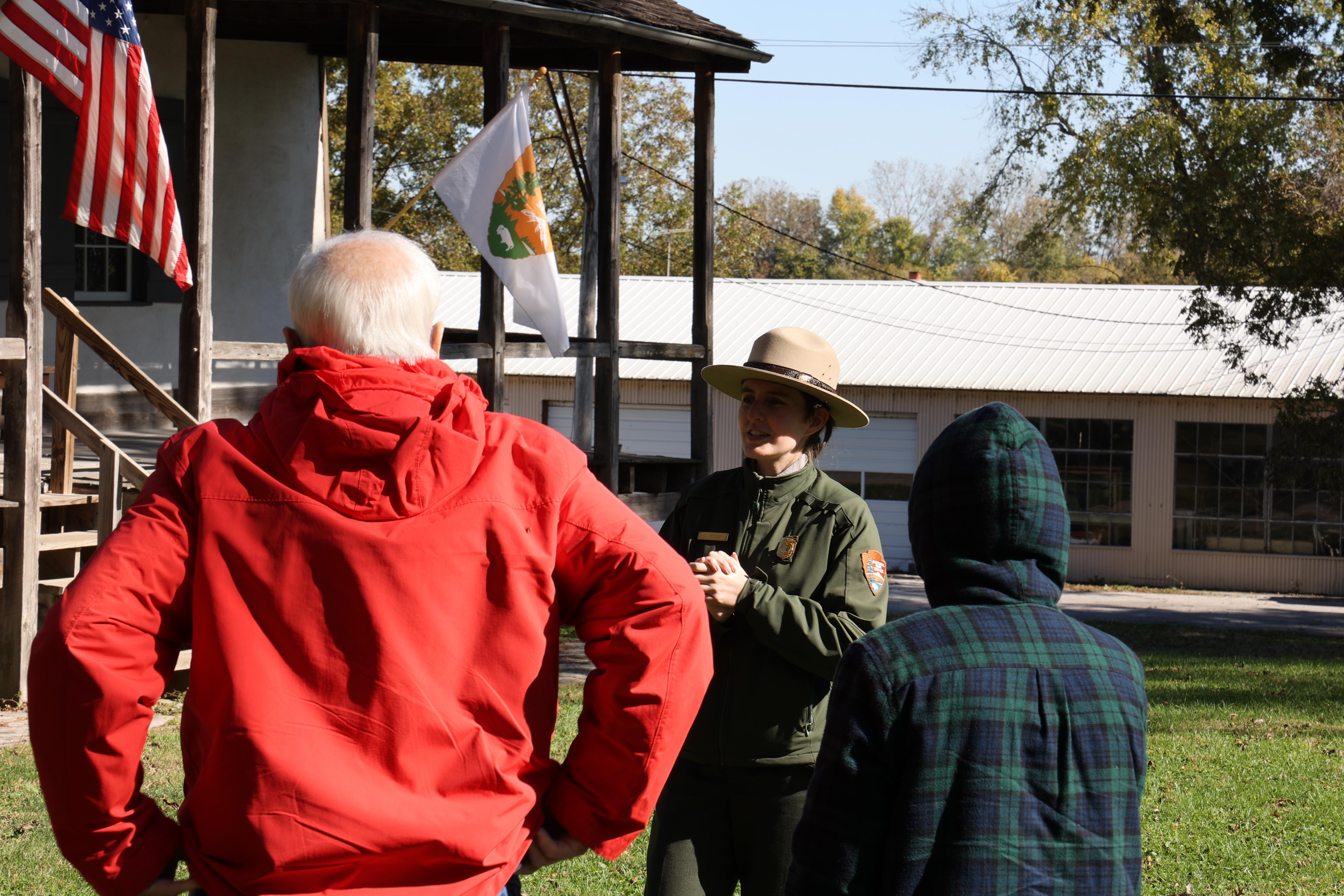 Park ranger stands in front of visitors at the Bauvais-Amoureux House on a cold day.