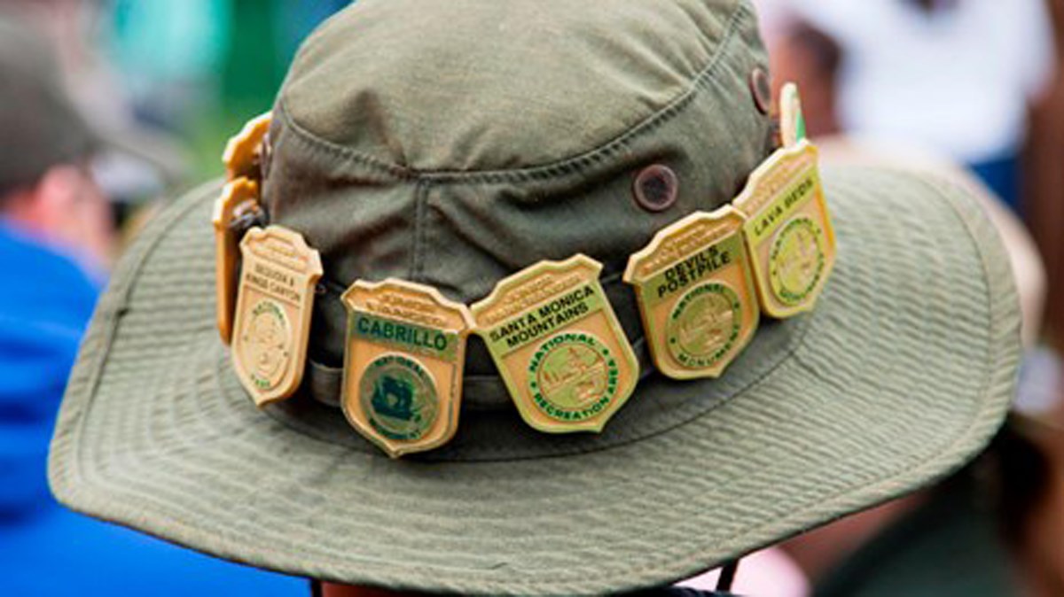 Junior Ranger brimmed hat with badges around the hat band.