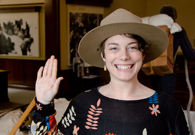 A woman in a ranger hat with her right hand raised. A woman in a ranger hat with her right hand raised.