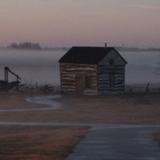 The Palmer-Epard Cabin rests at the end of the sidewalk with a hazy fog in the background. The Palmer-Epard Cabin rests at the end of the sidewalk with a hazy fog in the background.